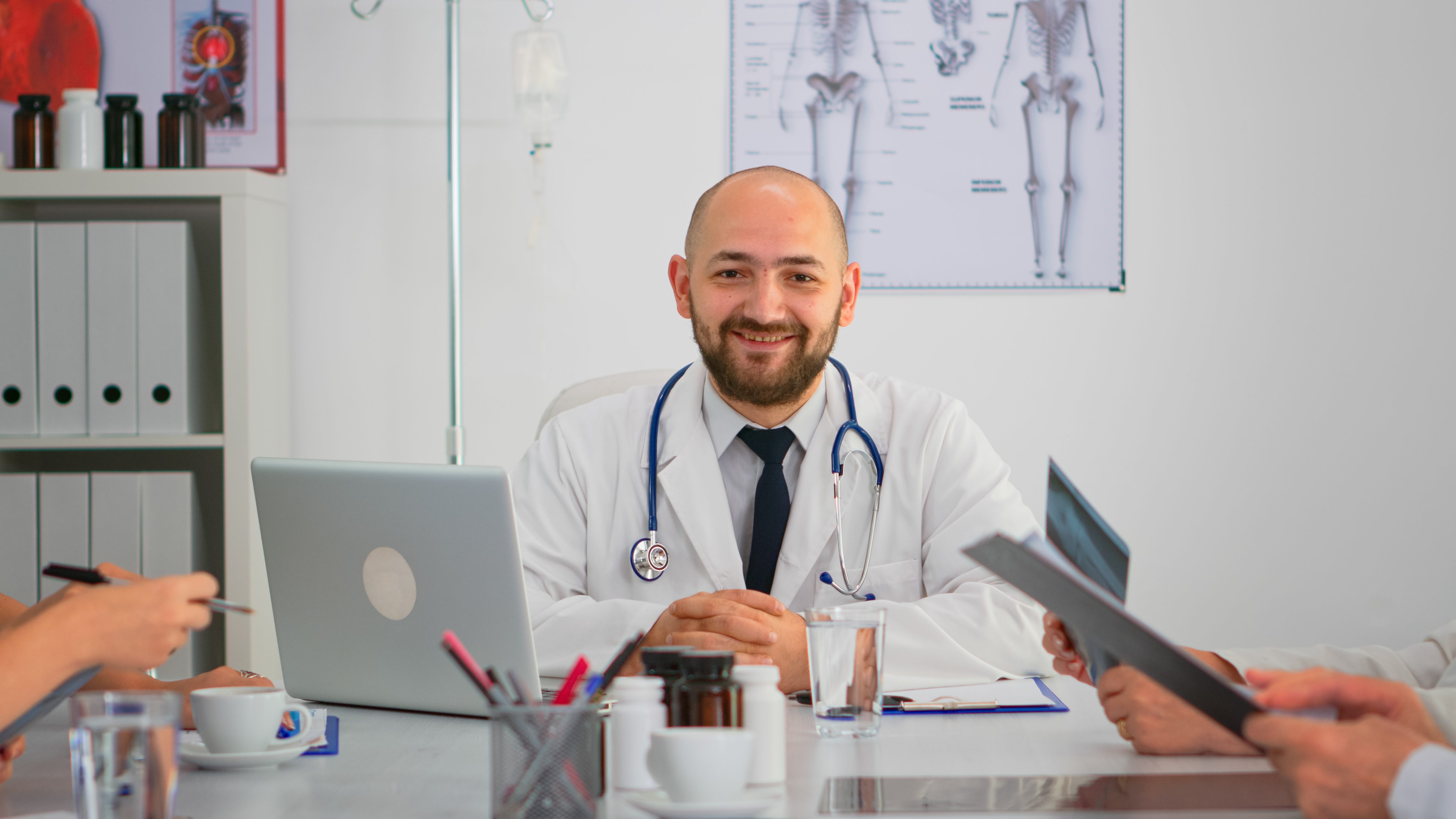 Doctor looking at camera smiling during brainstorm